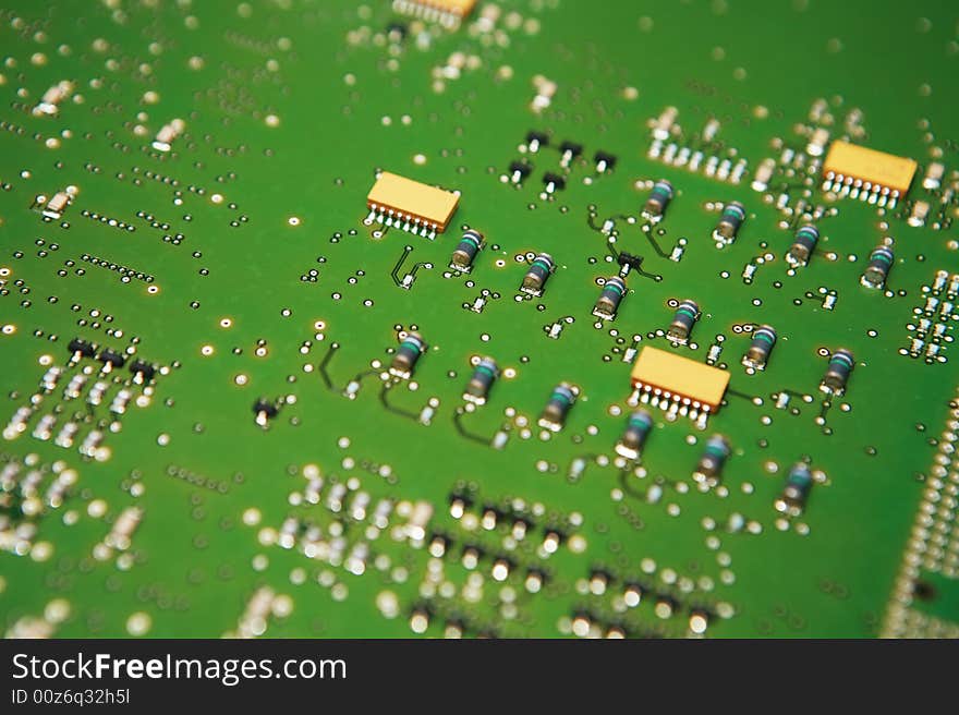 Closeup view of the component side of a circuit board. Capacitors,IC's,solder joints and traces showing. Closeup view of the component side of a circuit board. Capacitors,IC's,solder joints and traces showing.