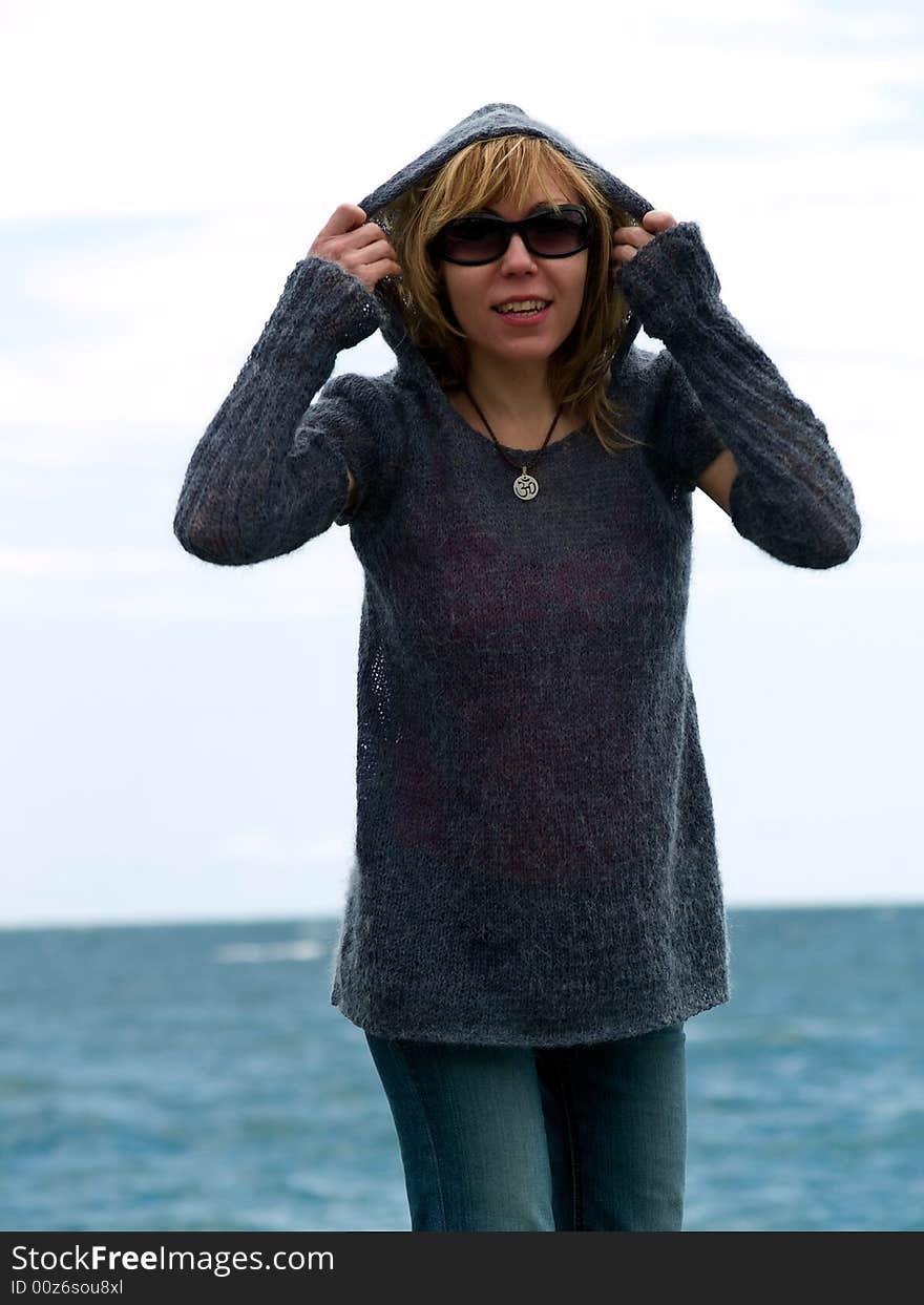 Blond Model in Hood Posing beach in Sunglasses