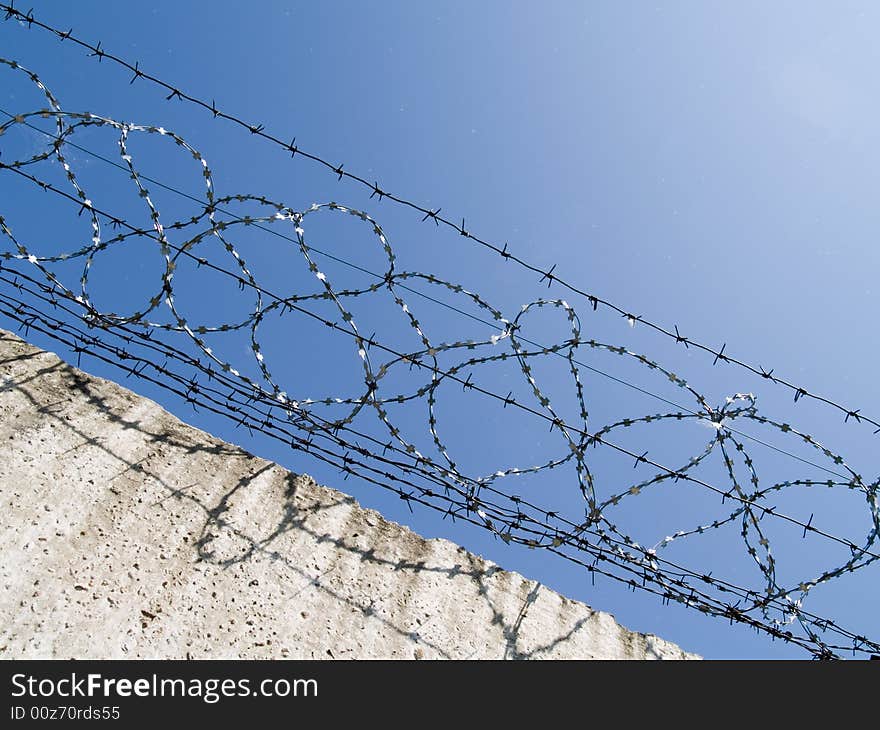 Barbed wire on a background blue sky