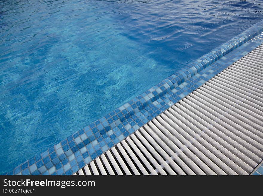 Swimming pool blue water in a summer day