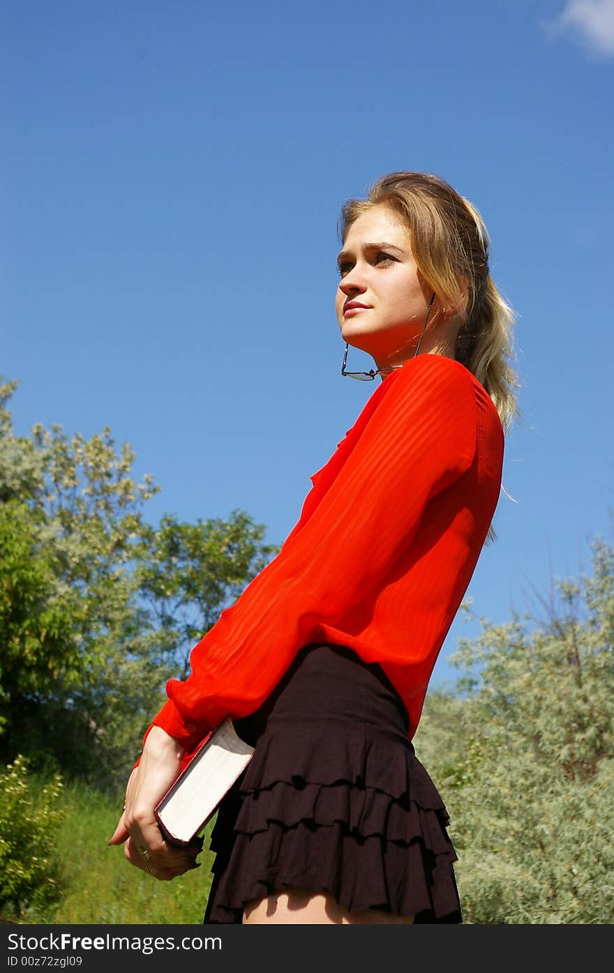 Cute woman in red holding a book