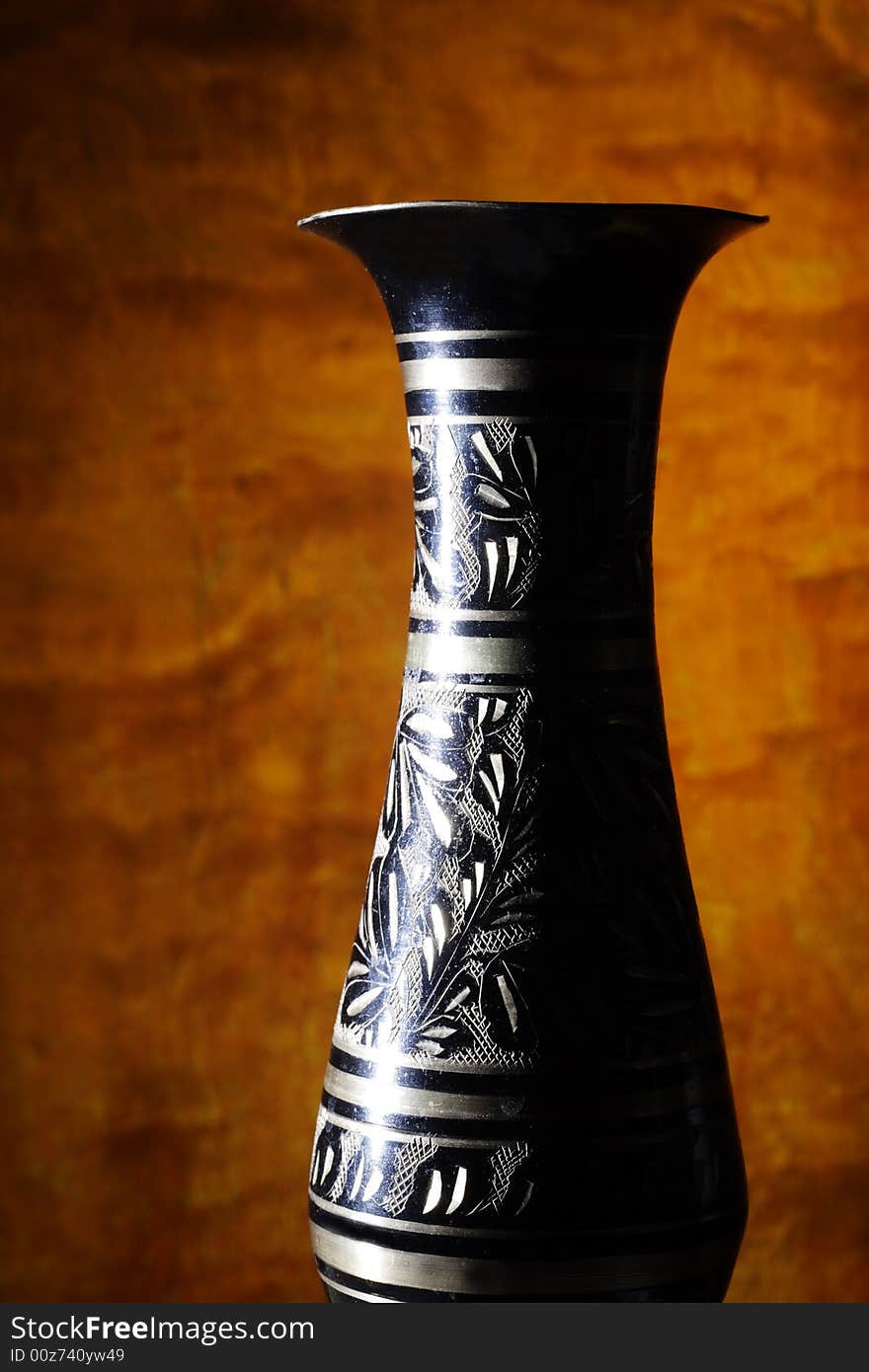 Vintage vase on wood background (focus on vase).