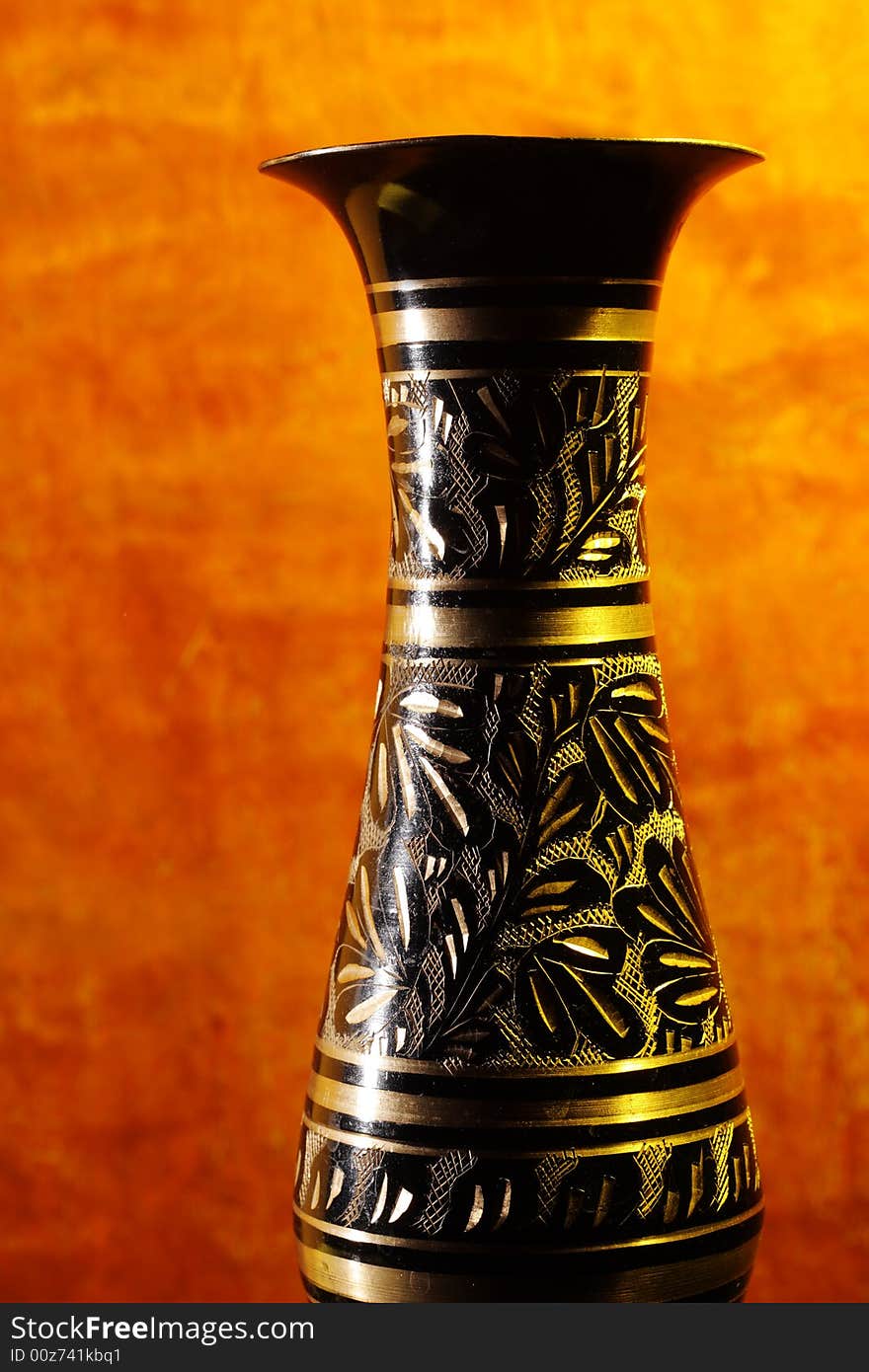 Vintage vase on wood background (focus on vase).