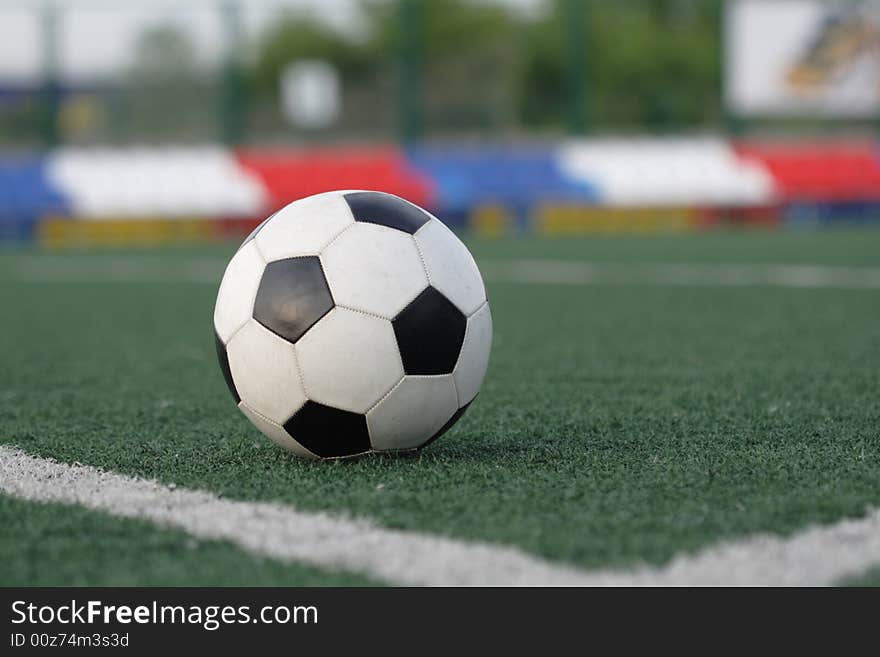 Football in stadium with an artificial covering before the beginning of game.