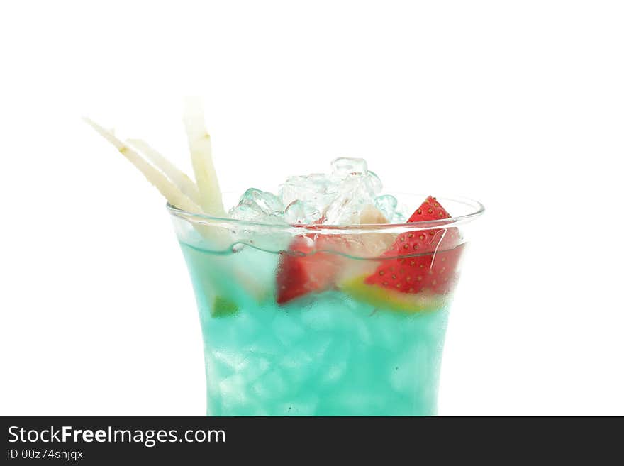 Tropical Acoholic Drink Made of Rum, Pineapple Juice, Blue Curacao, Sweet and Sour Mix. Slice of Apple and Strawberry as a Garnish. Tropical Acoholic Drink Made of Rum, Pineapple Juice, Blue Curacao, Sweet and Sour Mix. Slice of Apple and Strawberry as a Garnish.