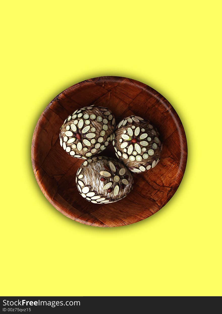 Handmade Easter eggs on yellow background