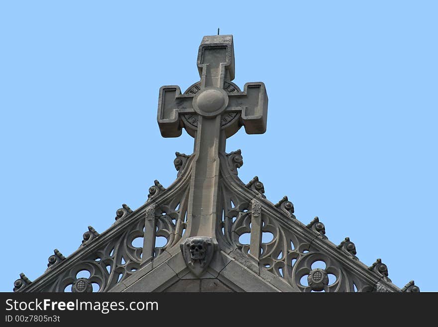 Cross on top of an old church with a bright blue sky background. Cross on top of an old church with a bright blue sky background