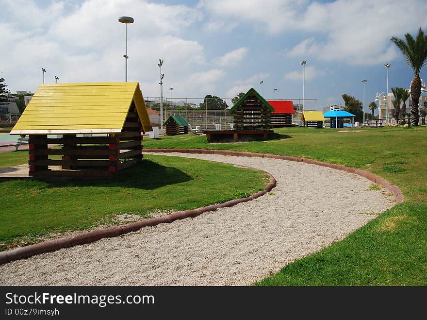 Children's cabins in green park on sea. Children's cabins in green park on sea