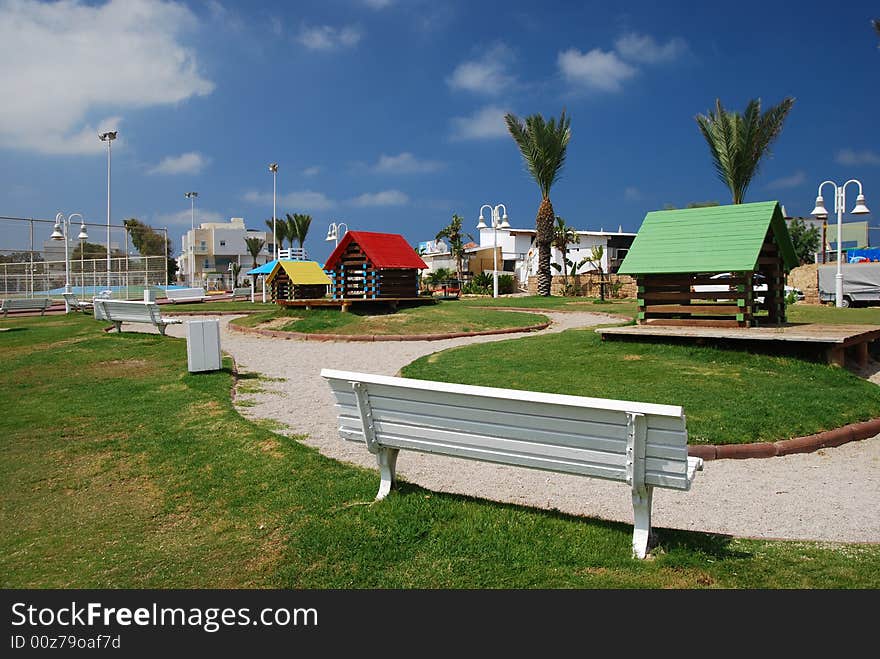 Children's cabins in green park on sea. Children's cabins in green park on sea