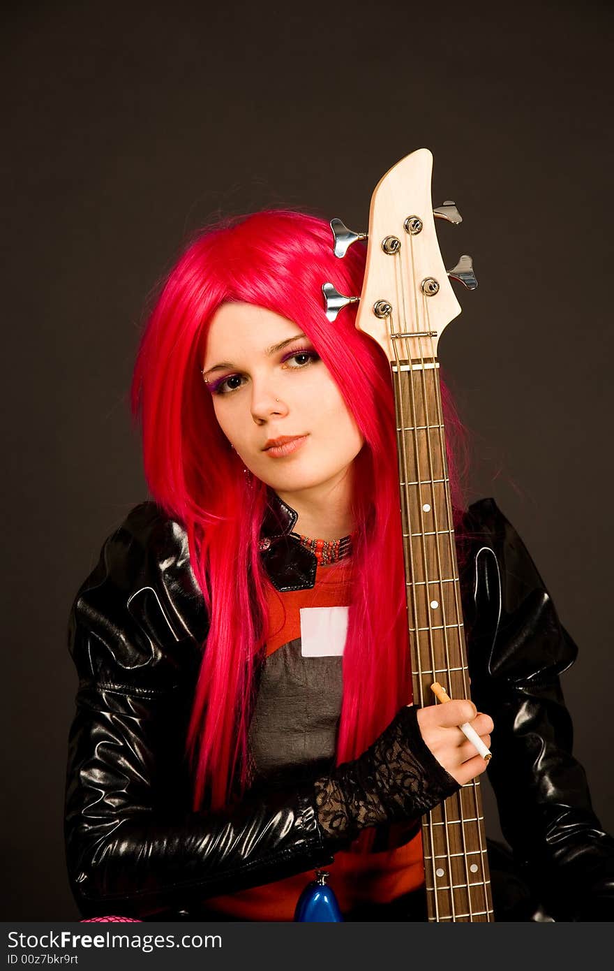 Romantic girl with guitar isolated on black background