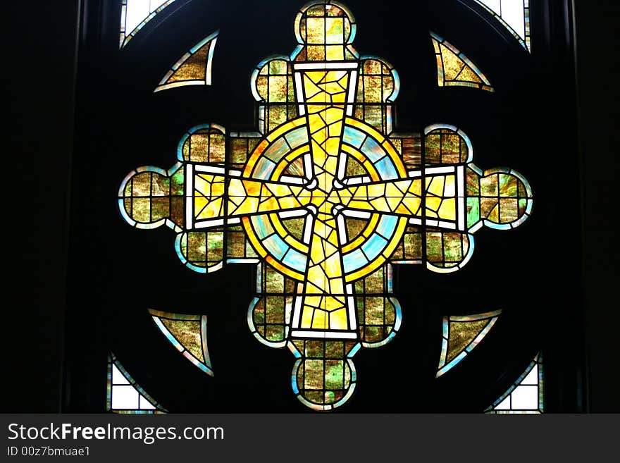 Stained glass window in the shape of a cross found in a church