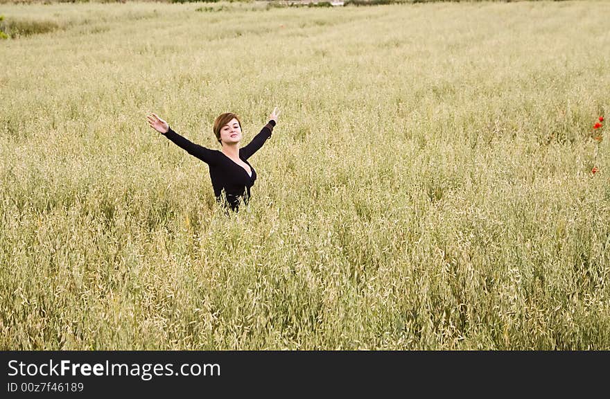 Woman feeling freedom in a field. Woman feeling freedom in a field.