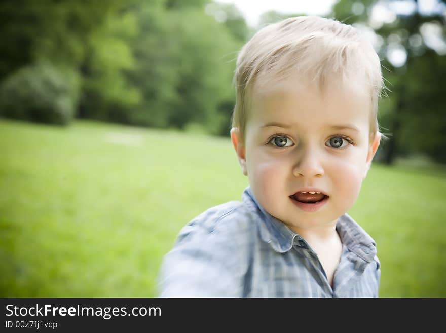 Little Kid Portrait On The Nature Background. Little Kid Portrait On The Nature Background