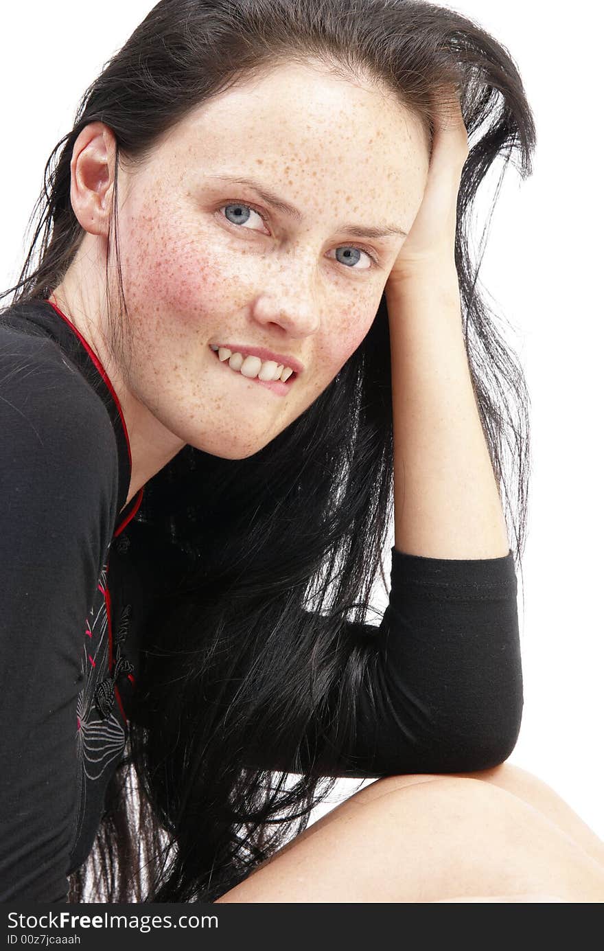 Portrait of a beautiful brunette woman with light blue eyes and freckles on her skin. Portrait of a beautiful brunette woman with light blue eyes and freckles on her skin