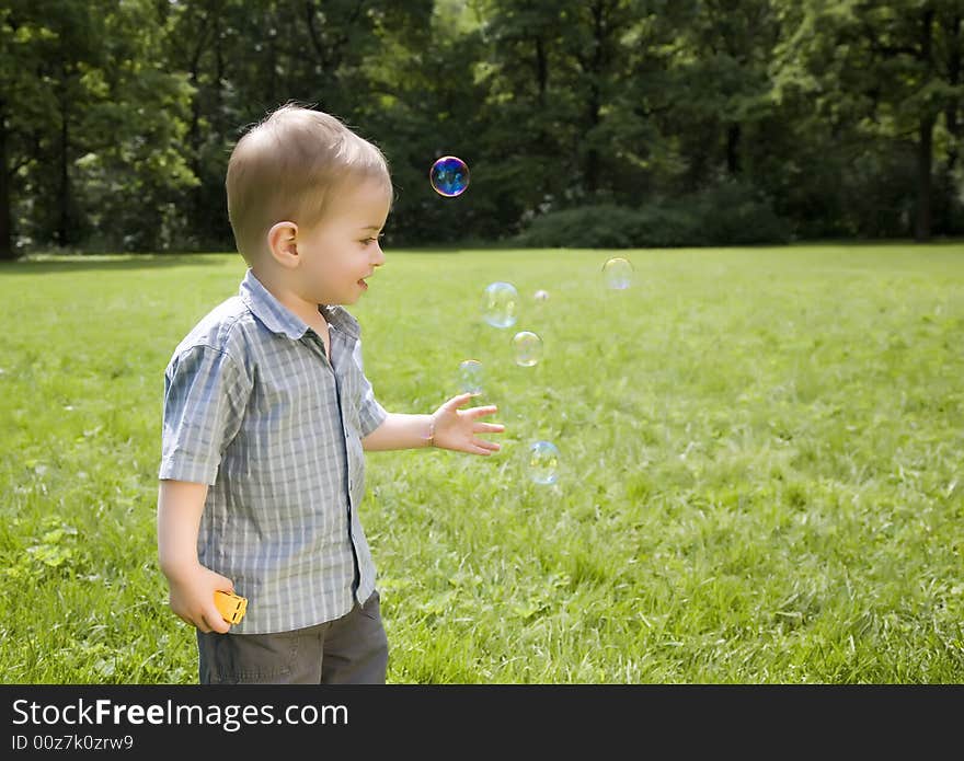 Little Boy Blowing Soap Bubbles