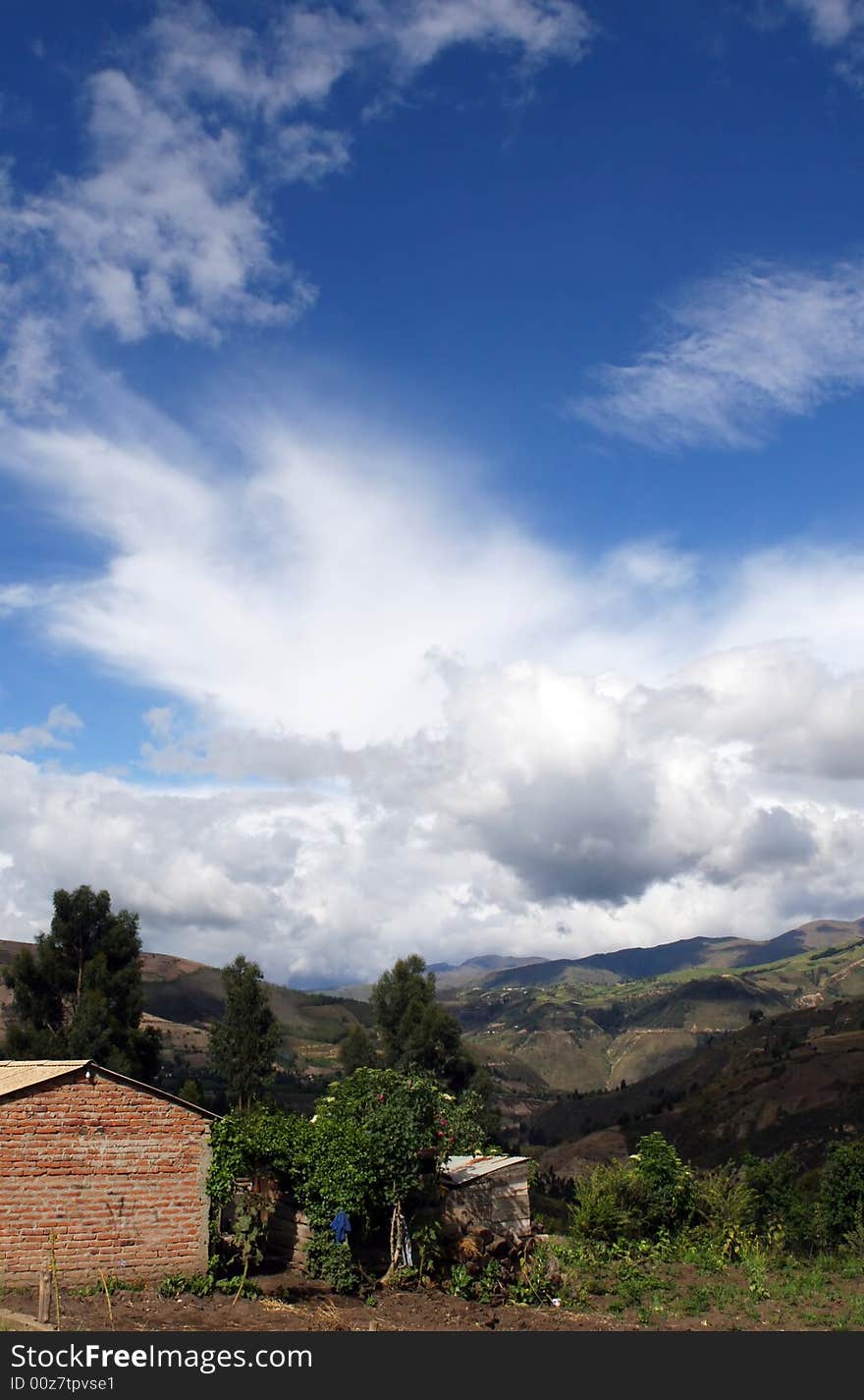 A cloudscape forms over a small house in rural Ecuador. A cloudscape forms over a small house in rural Ecuador