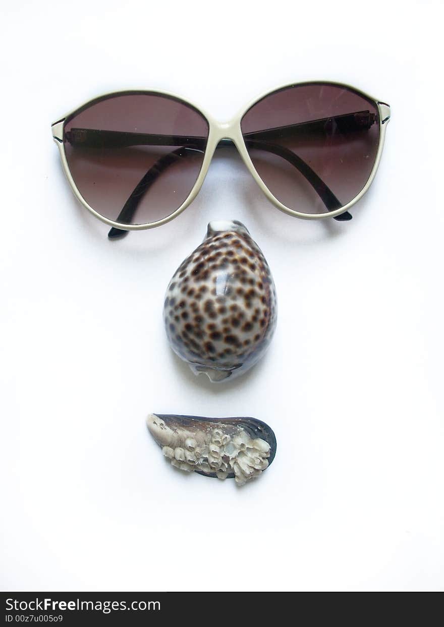 Face. solar glasses and seashells