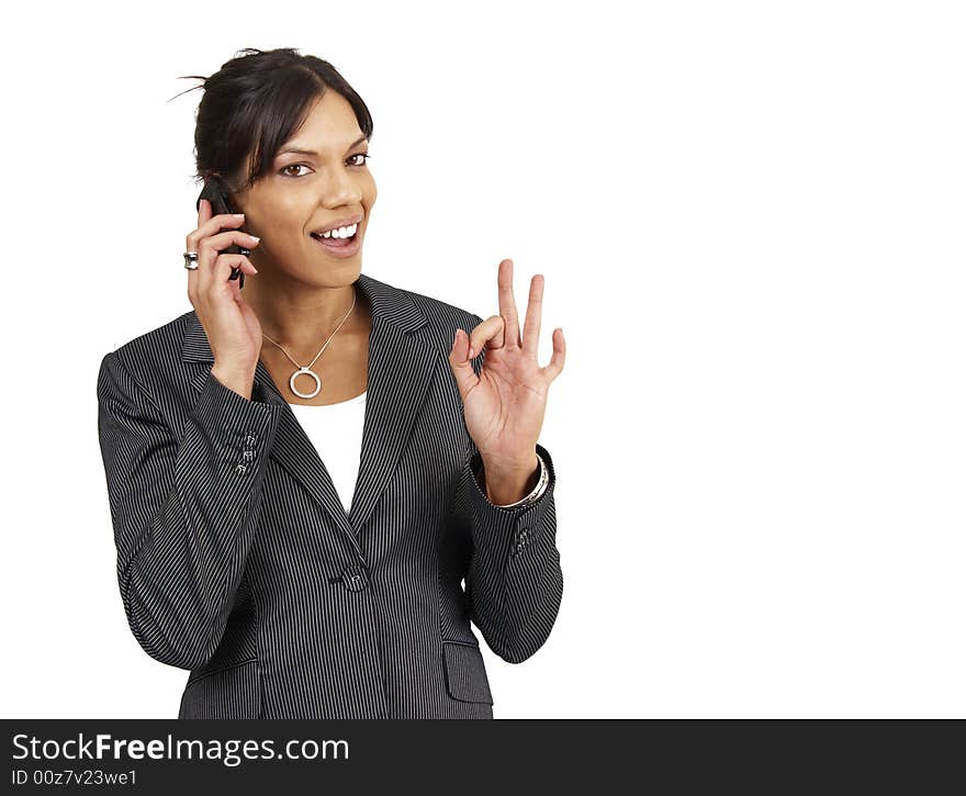 Beautiful brunette woman in pinstripe suit talking on her cellphone. Isolated on white background with copy space