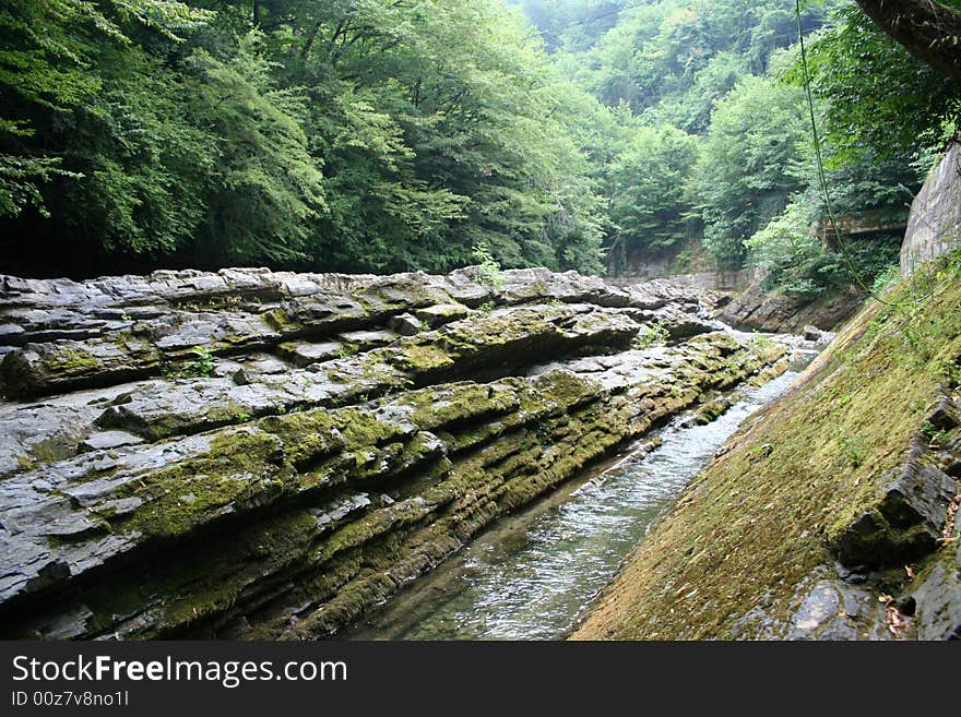 Mountain river in encirclement granite declivity