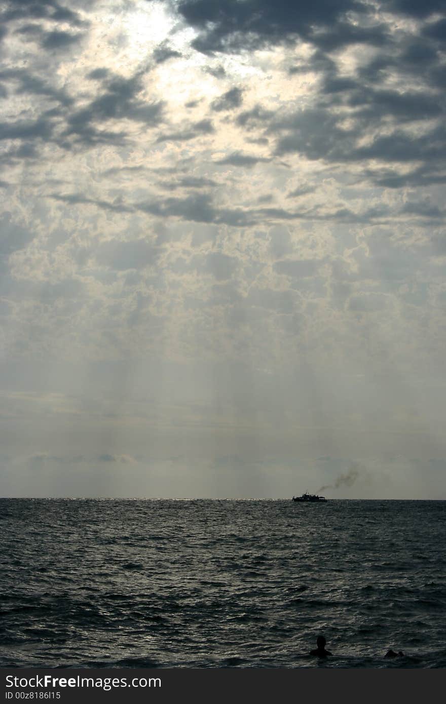 Sea wave illuminated year evening sun on background blue skyd sky