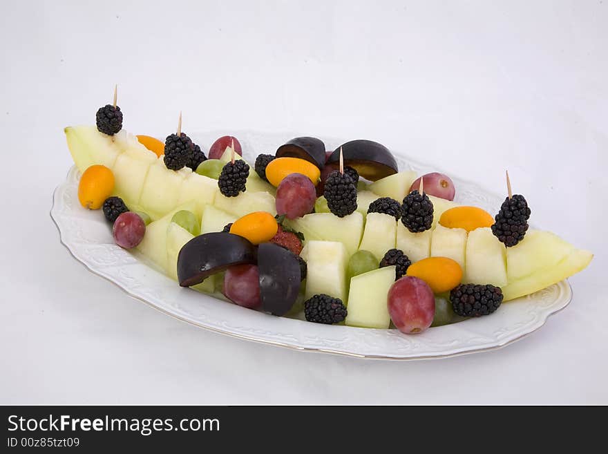 Fruits in the plate, on the white background