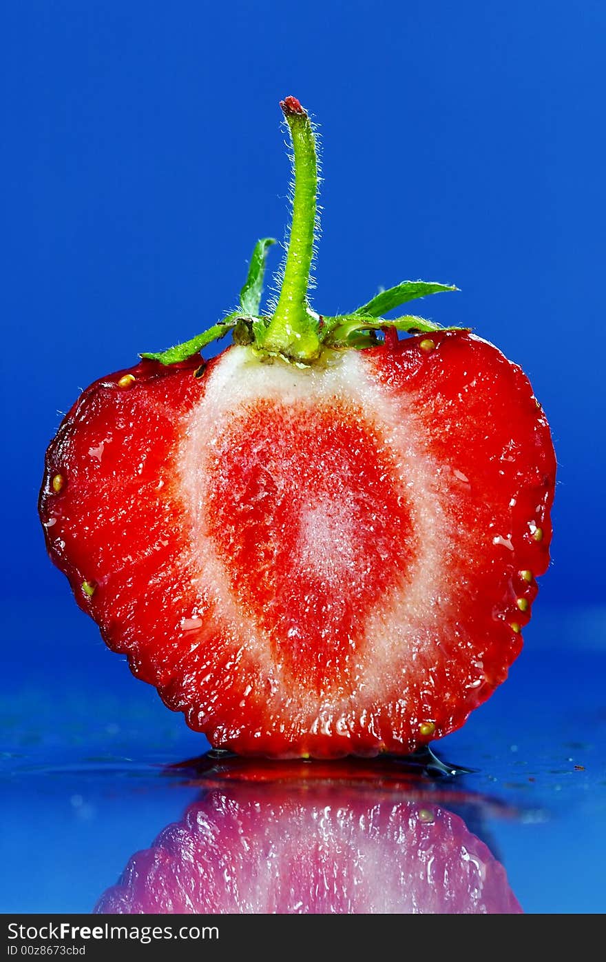 Slice of a strawberry on blue background