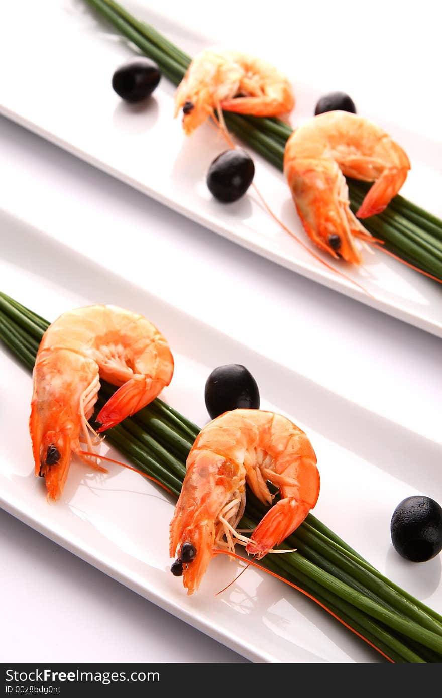 Fresh shrimps with chive and oil on white plate