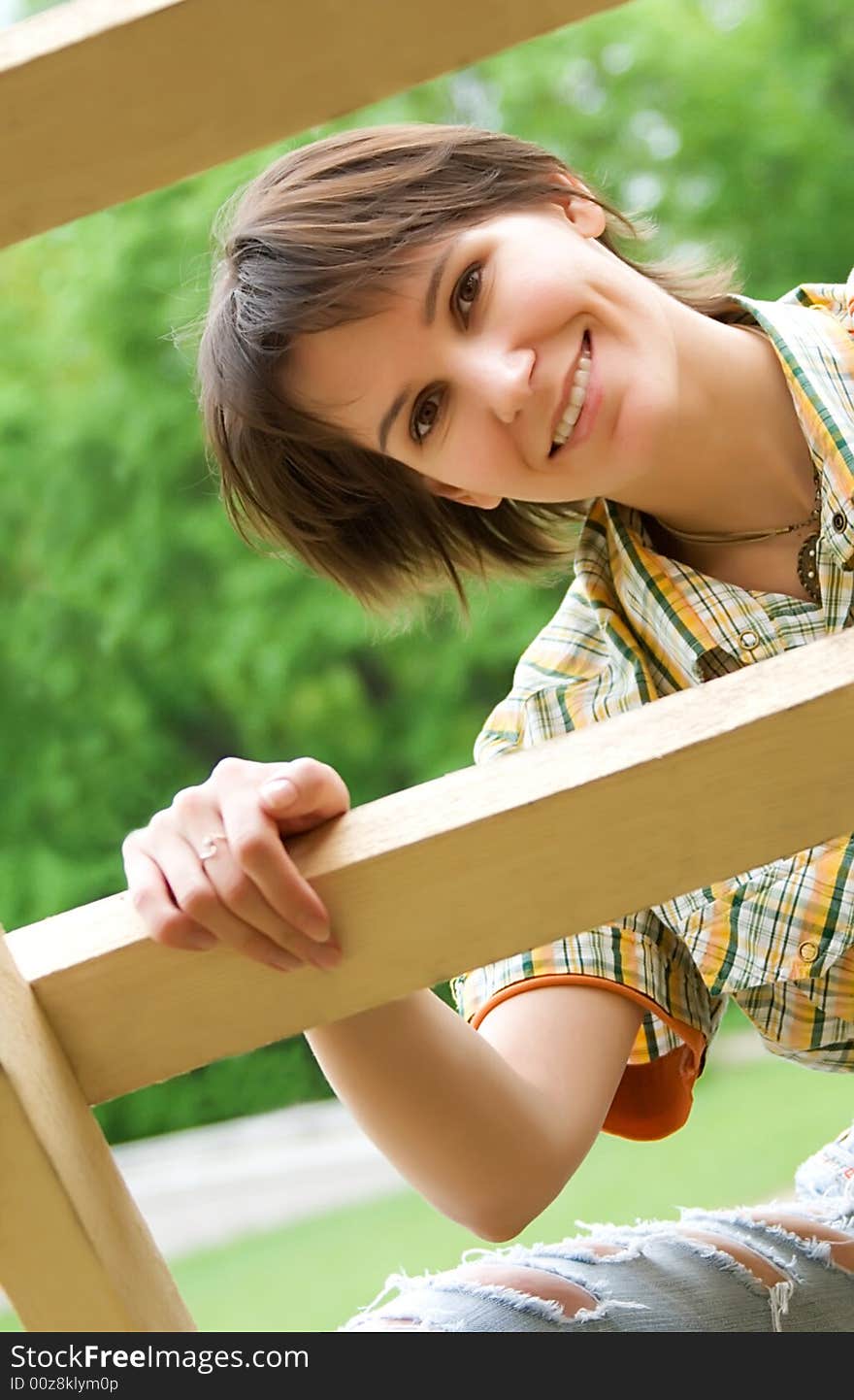 Young woman on a wooden ladder. Young woman on a wooden ladder.