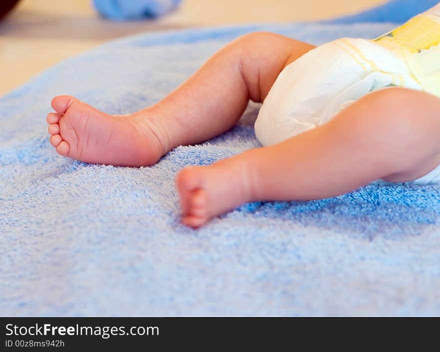 Newborn's legs on bathing towel before bath