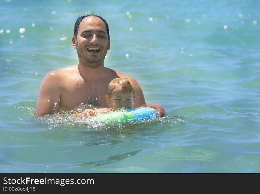 Father and son swimming in the sea