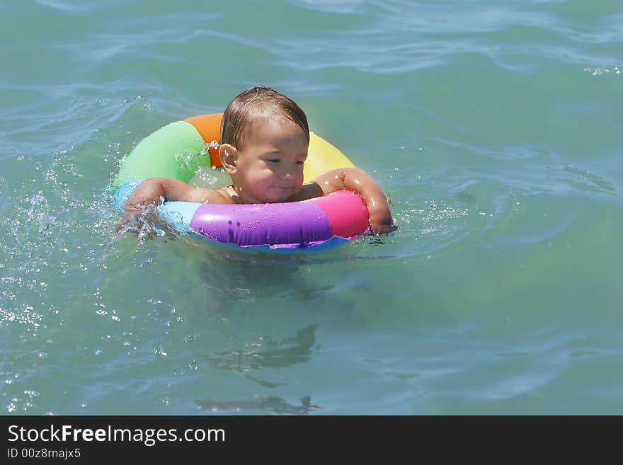 Baby swimming in the sea. Baby swimming in the sea