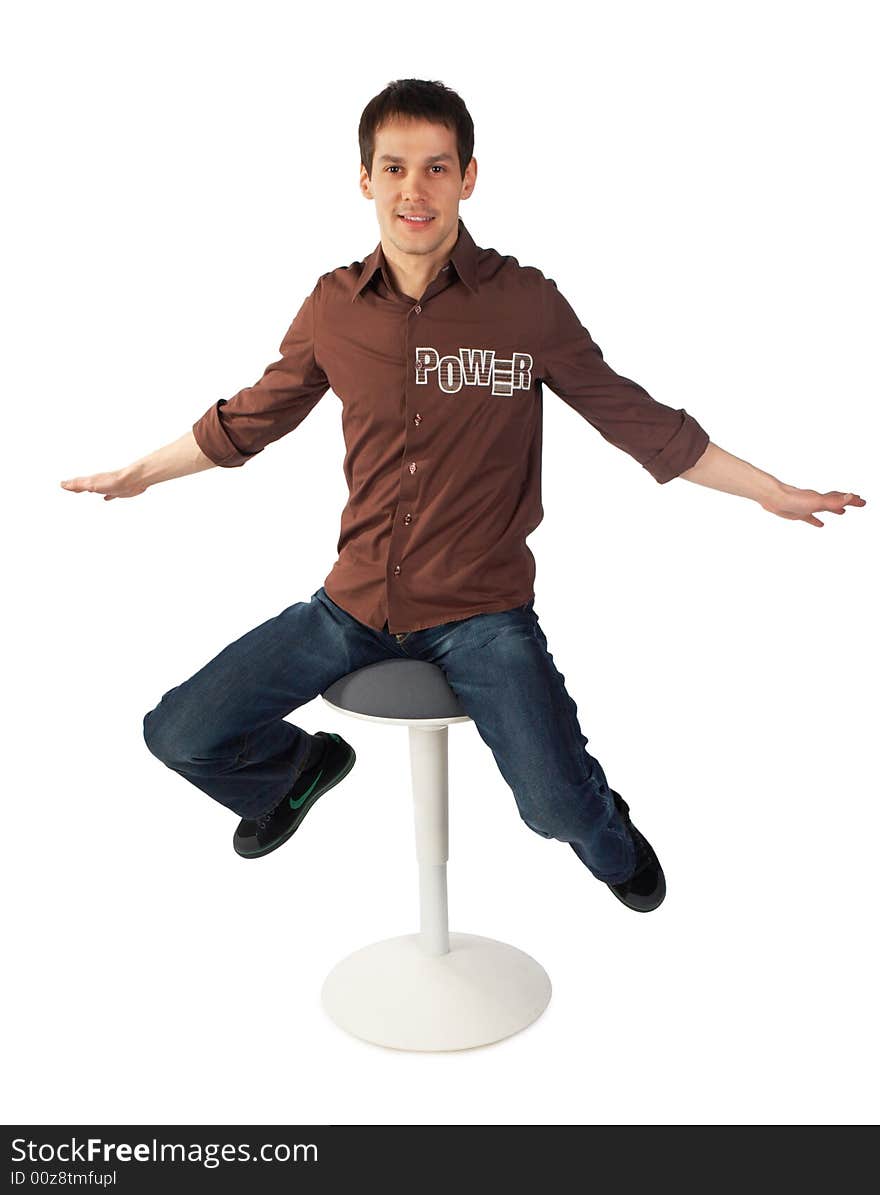 Young man sits on stool. Isolated on white.