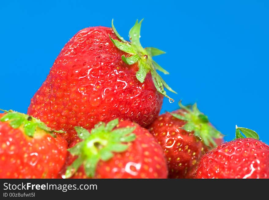 Close up on fresh strawberries on blue background