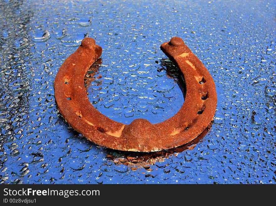 Old Horseshoe On The Water Drops Background