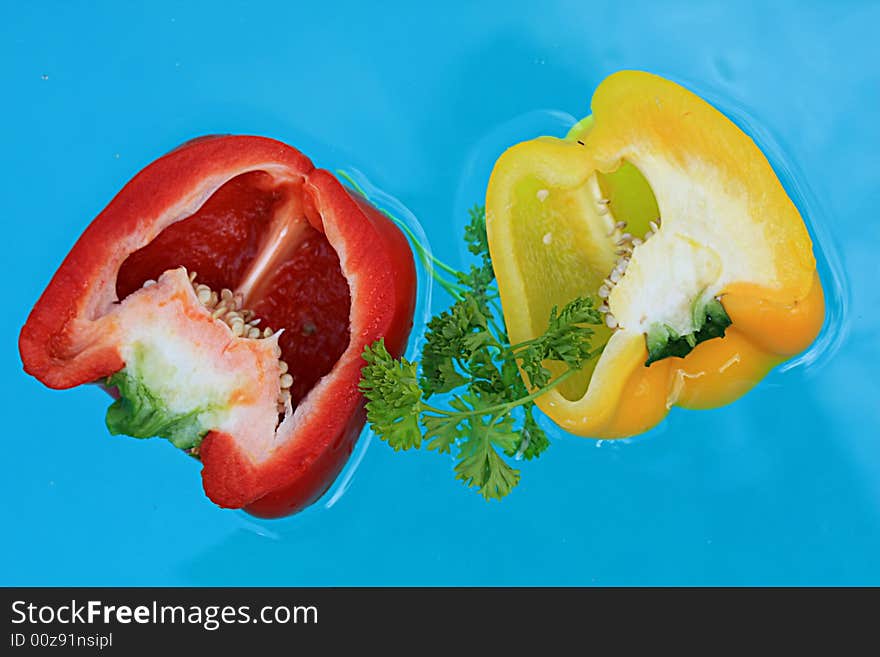 Floating fresh  peppers   with blue water background