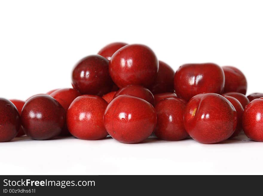 A lot of fresh red cherry with drops on background