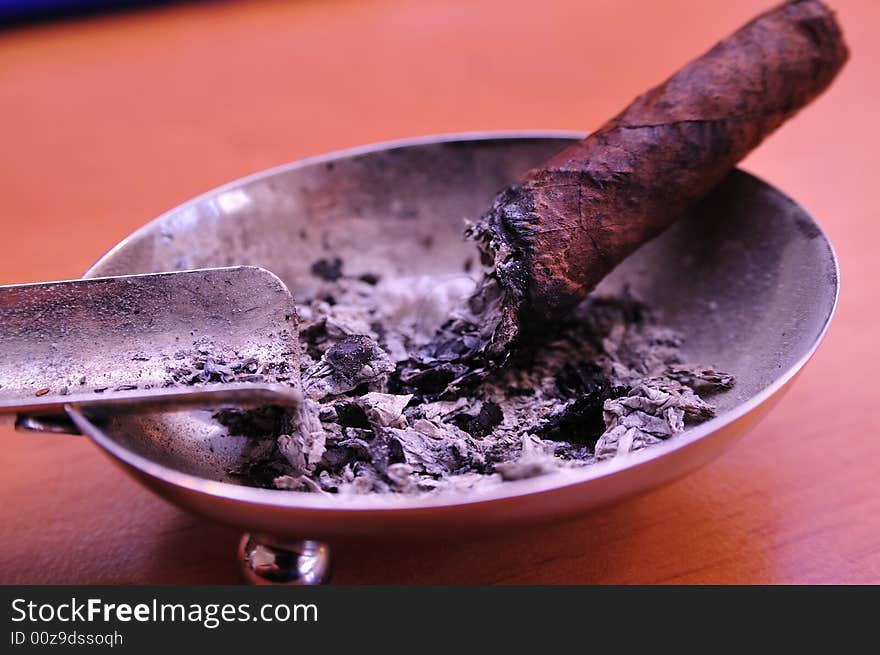 Small Cigar in an old dirty Ashtray, Close shot. Small Cigar in an old dirty Ashtray, Close shot