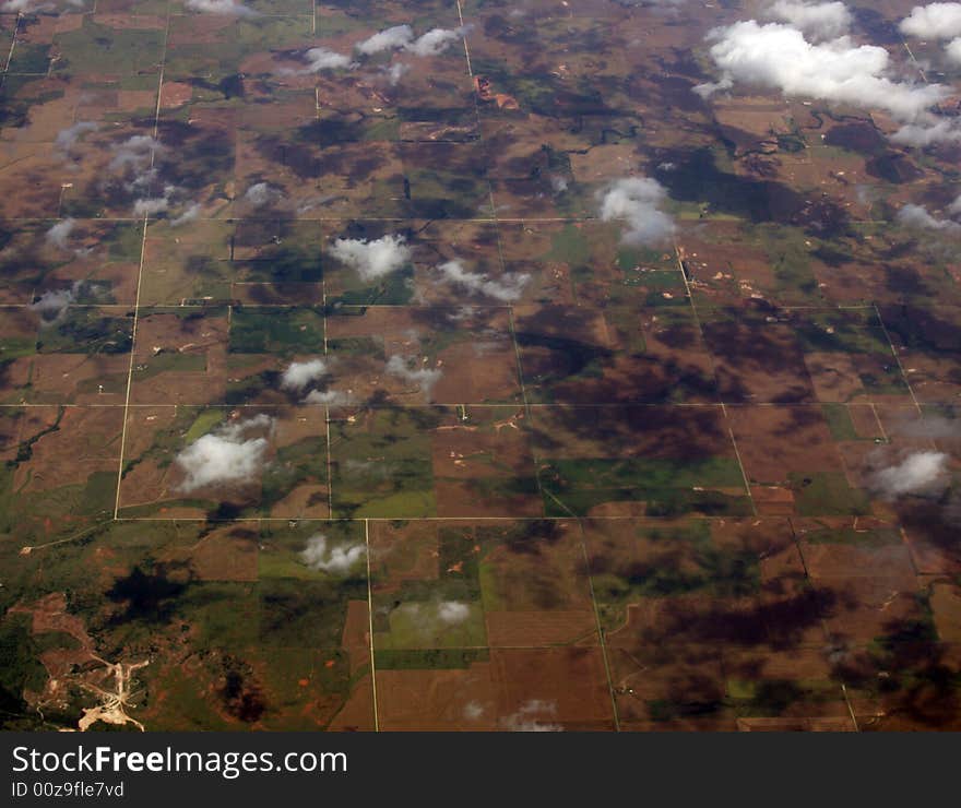 Crop fields with puffs of clouds and shadows. Crop fields with puffs of clouds and shadows.