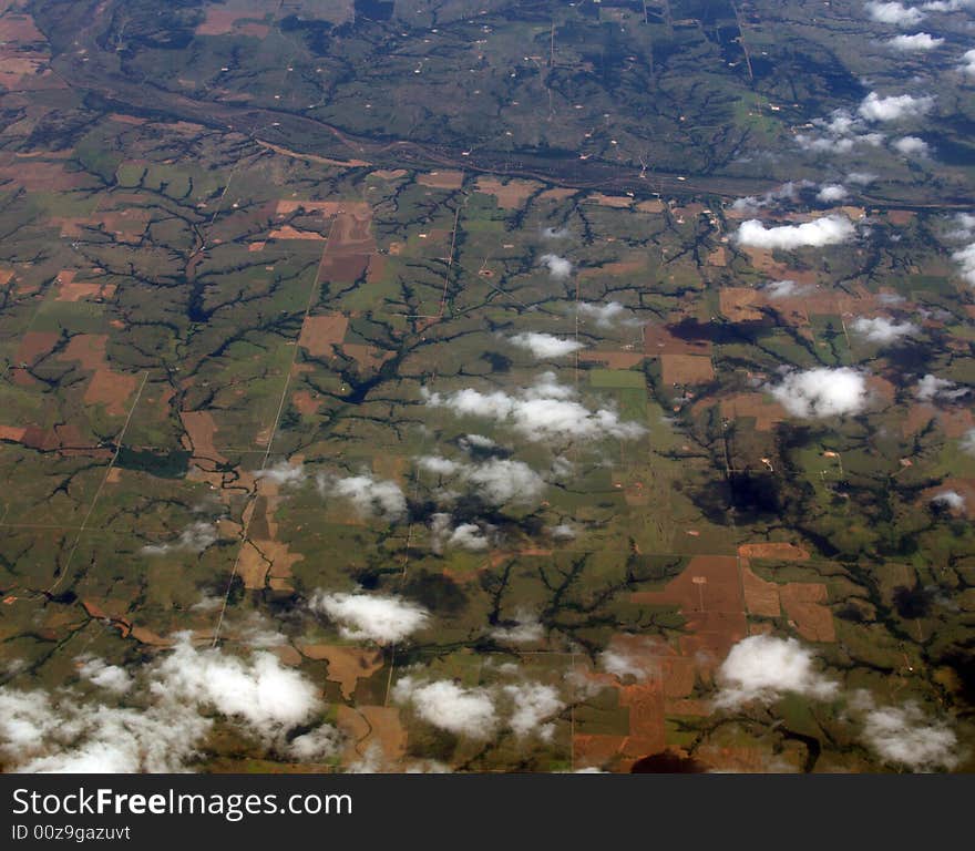 Line formation of clouds across some farmland. Line formation of clouds across some farmland.