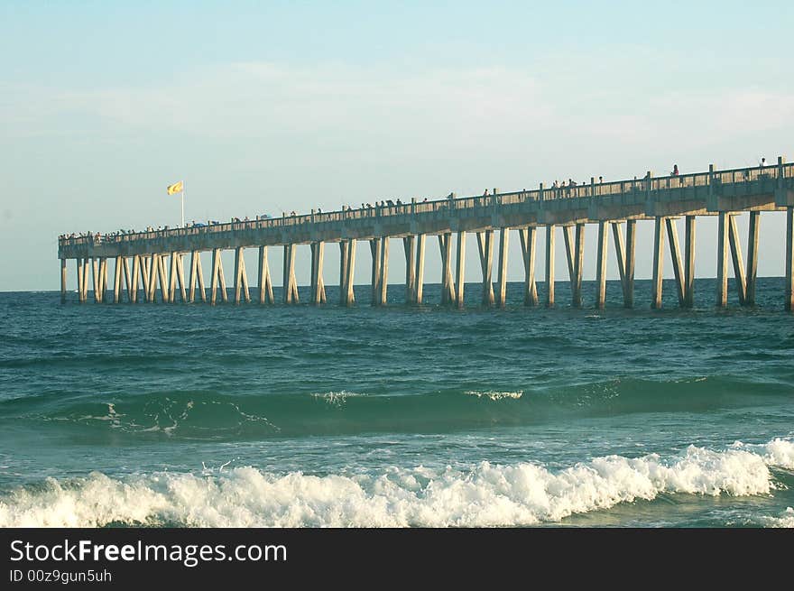 Fishing pier crowded with fisherman in the early morning