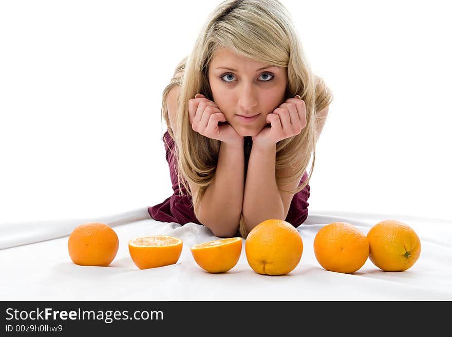 Beautiful girl thinks of oranges. Isolated over white