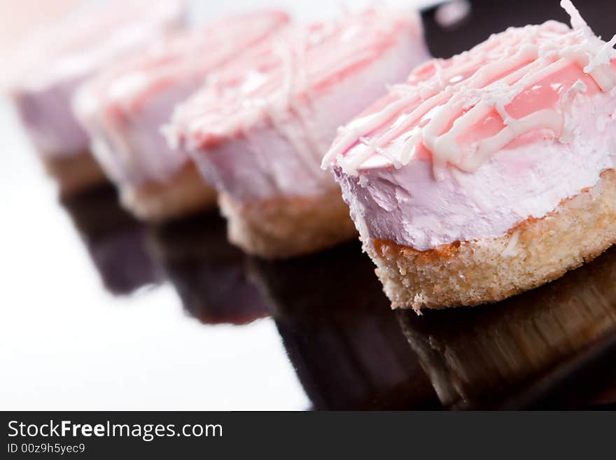 Small cakes on black plate