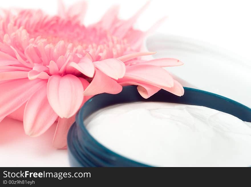 Moisturizing cream with pink gerbera close up