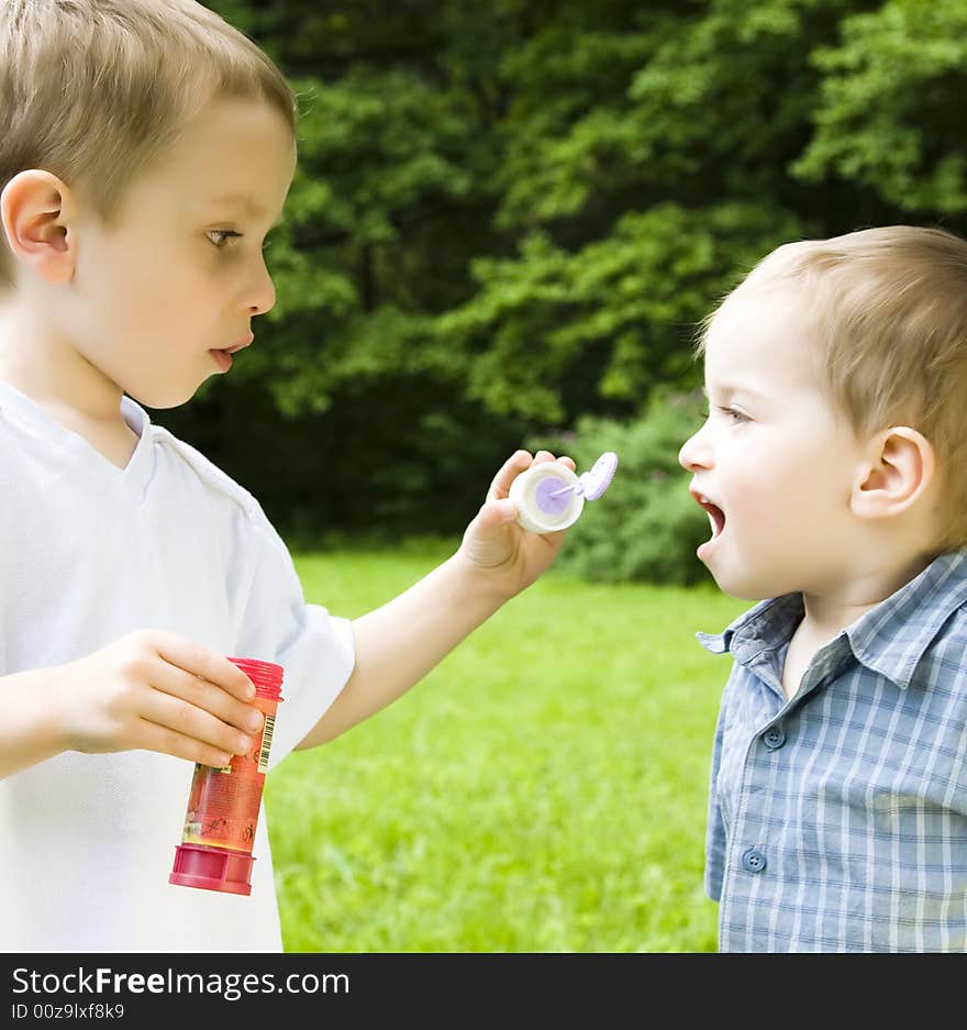 Two Boys Playing With Soap Bubbles