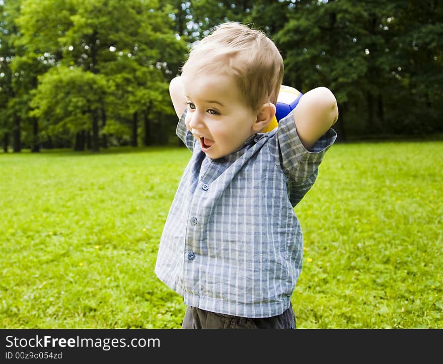 Young Baby Playing With Ball Outdoors