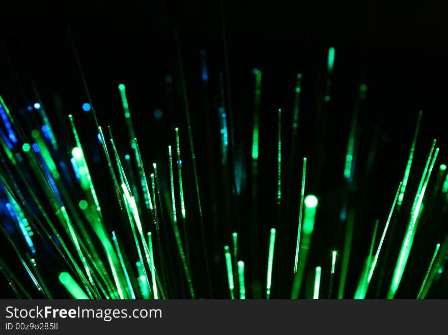 Green and blue fiber optic lights, black background. Green and blue fiber optic lights, black background