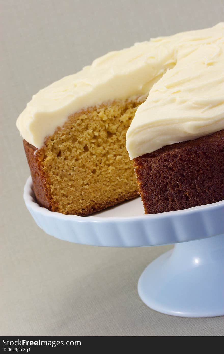 A freshly baked caramel cake with creamed butter icing.