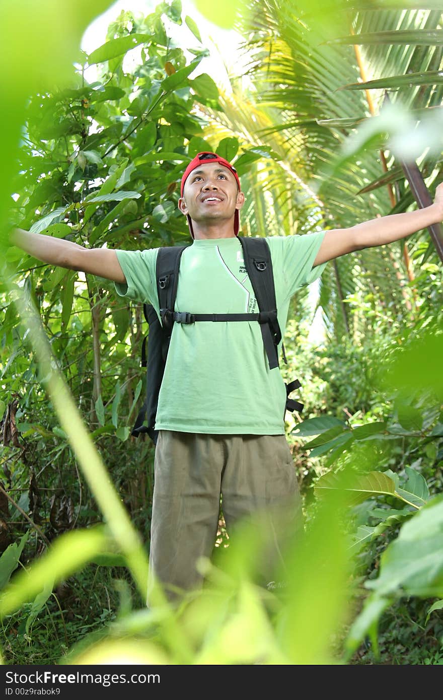 Hiking man enjoy in forest, framed in trees