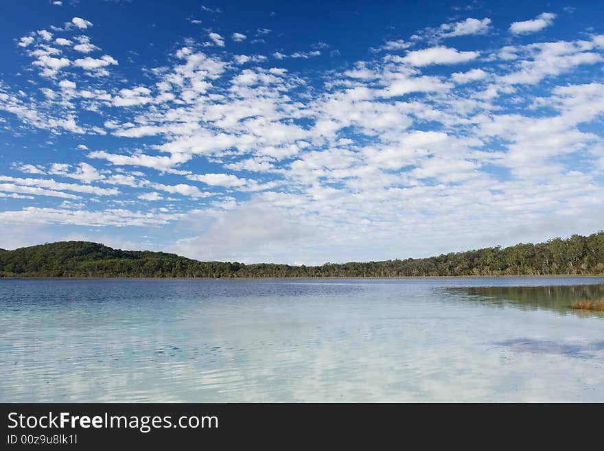 Lake McKanzie in Fraser Island and beautiful blue sky with some nice white clouds. Lake McKanzie in Fraser Island and beautiful blue sky with some nice white clouds.