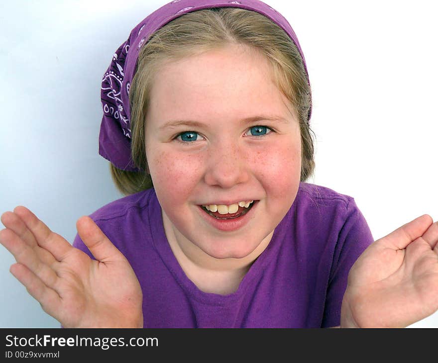 A blonde girl with big blue eyes looking happy and surprised. A blonde girl with big blue eyes looking happy and surprised